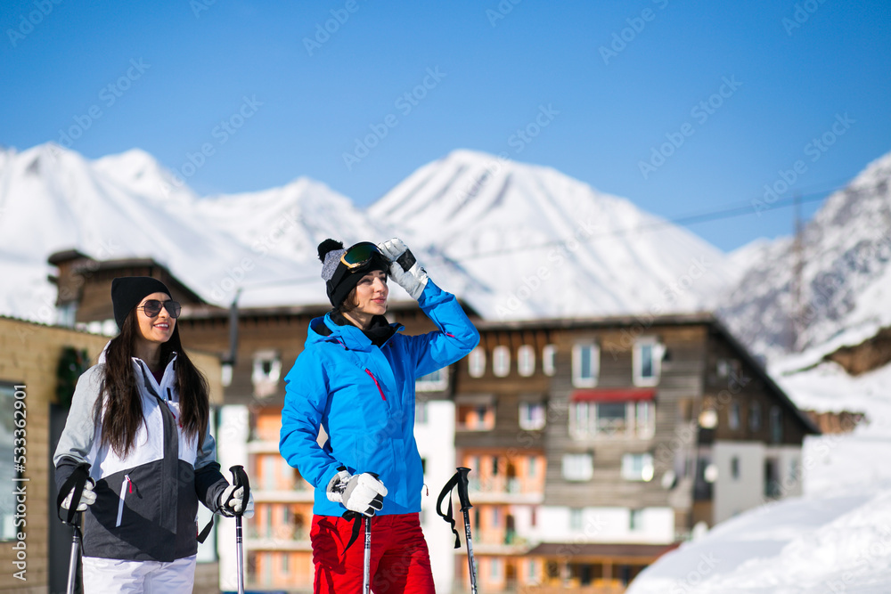 Girls friends skiing in the mountains