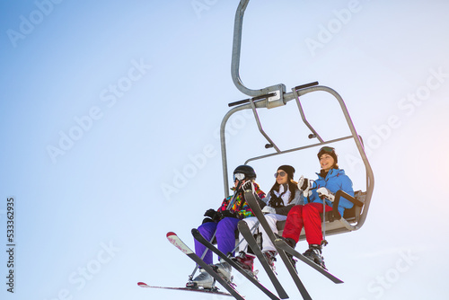 Obraz na plátně Girl on ski lift high in the mountains
