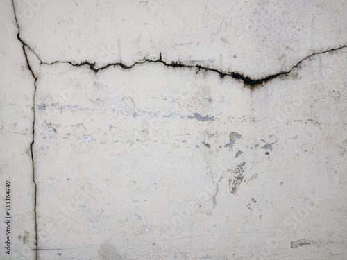 Cracked white concrete wall Suitable for your designs and work surfaces.