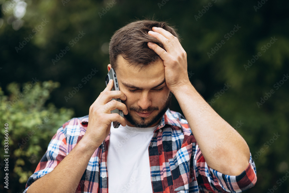 Young man emotionally talking on the phone Young man emotionally talking on the phone
