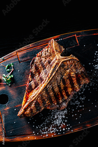 Grilled T-bone Steak on bones on wooden board