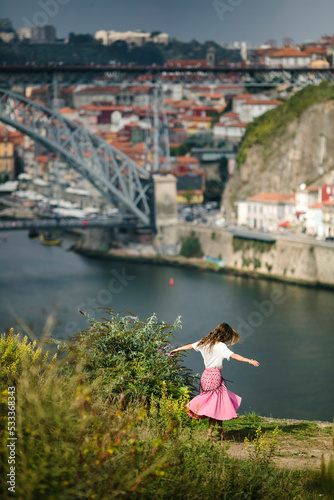 A woman dancing on the bank of a Douro river, Porto, Portugal. © De Visu