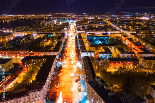 Top view of the night city in winter. Movement of cars on lighted streets and intersections photo