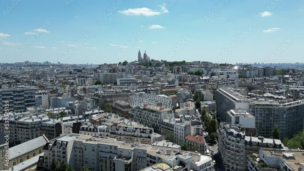 Paris 17th district or 17ème arrondissement with Montmartre and Sacre Coeur or Sacred Heart basilica in background. Aerial drone view. Sky for copy space Paris 17th district or 17ème arrondissement with Montmartre and Sacre Coeur or Sacred Heart basilica in background. Aerial drone view. Sky for copy space