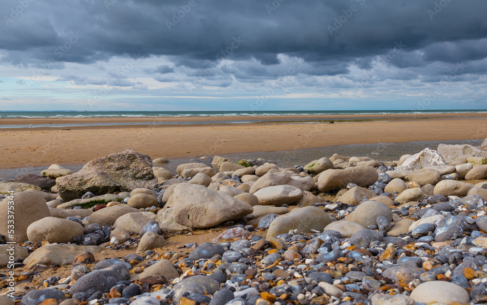 low tide on the french beach with lot of stones low tide on the french beach with lot of stones