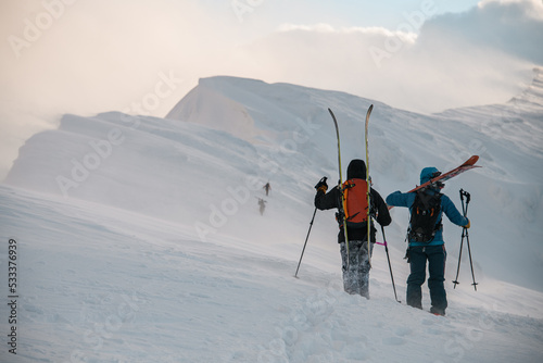 rear view of skiers on snow-covered mountain. Ski touring and freeride concept