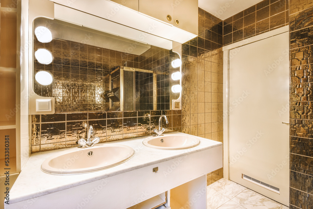 Sink next to a mirror with brown walls Sink next to a mirror with brown walls