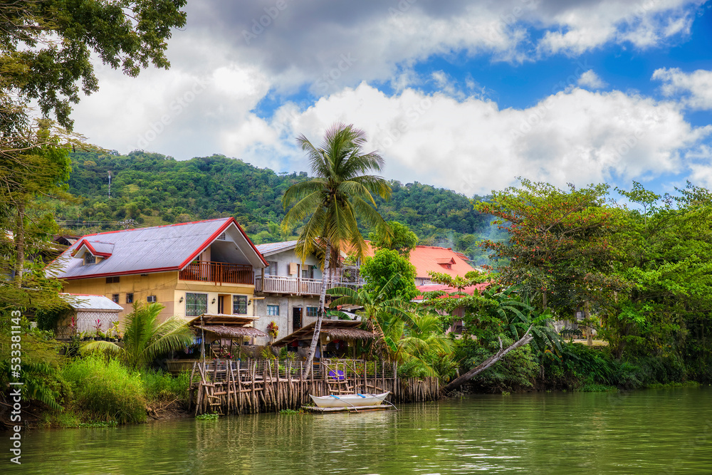 Loboc River and Houses in the Village of Loboc, Bohol, Philippines Loboc River and Houses in the Village of Loboc, Bohol, Philippines