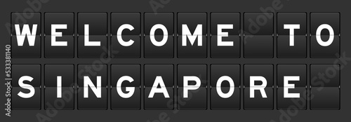 Black color analog flip board with word welcome to singapore on gray background