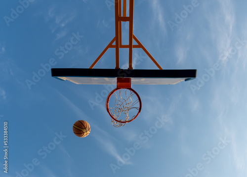 Basketball hoop and ball to score on a game taken with a down angle