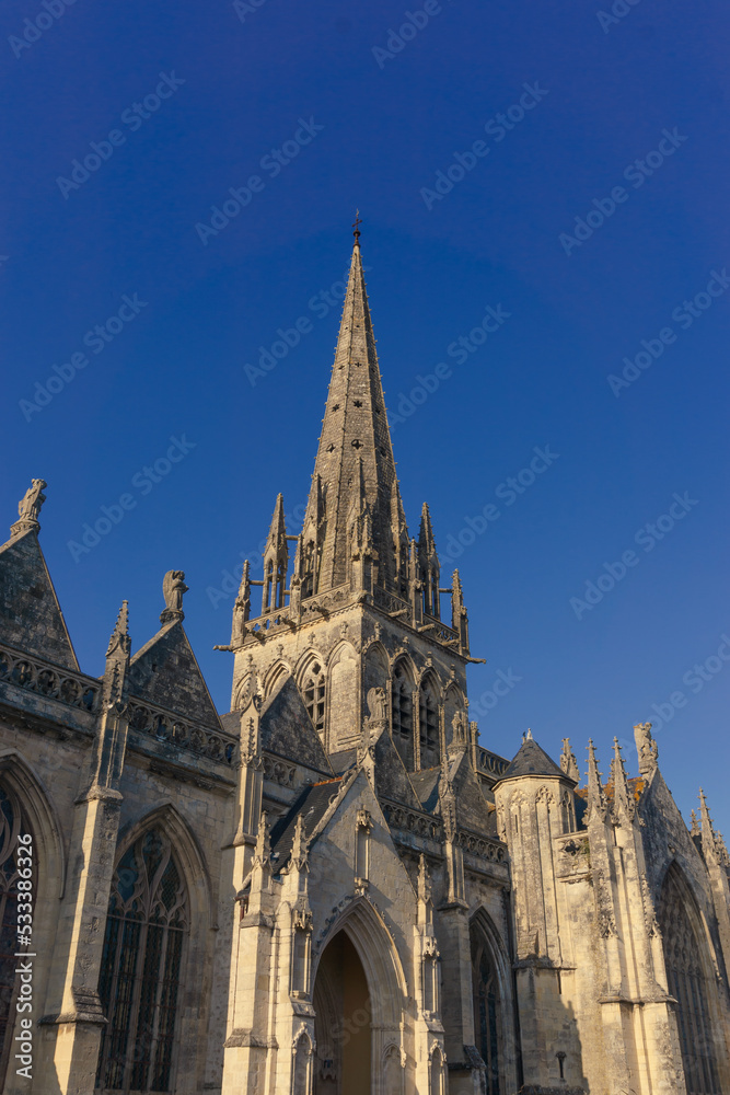 A view of the Notre-Dame church with blue summer sky in the centre of Carentan, Normandy, France