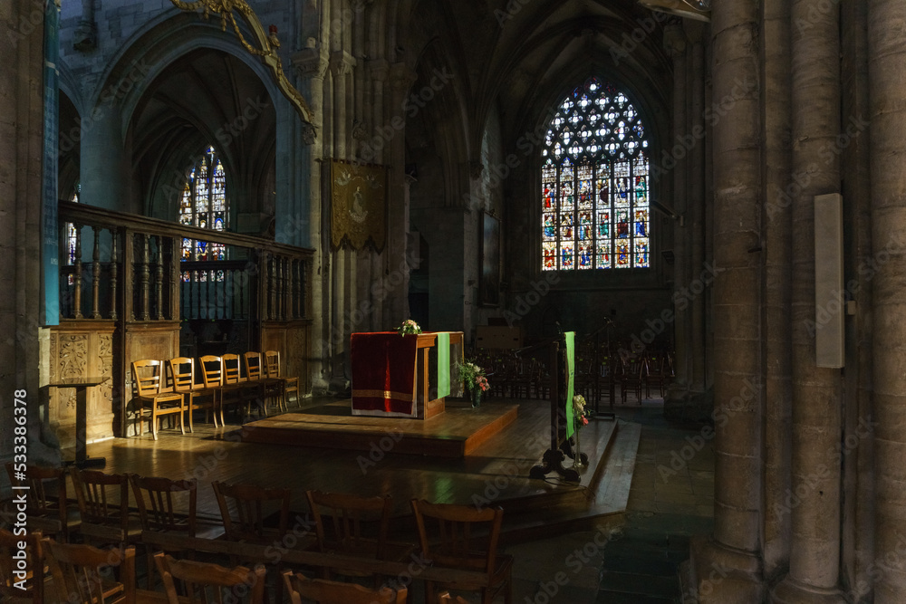 Fototapeta premium Interior of the Church of Notre-Dame with altar and colorful windows in the french town of Carentan, Normandy, France