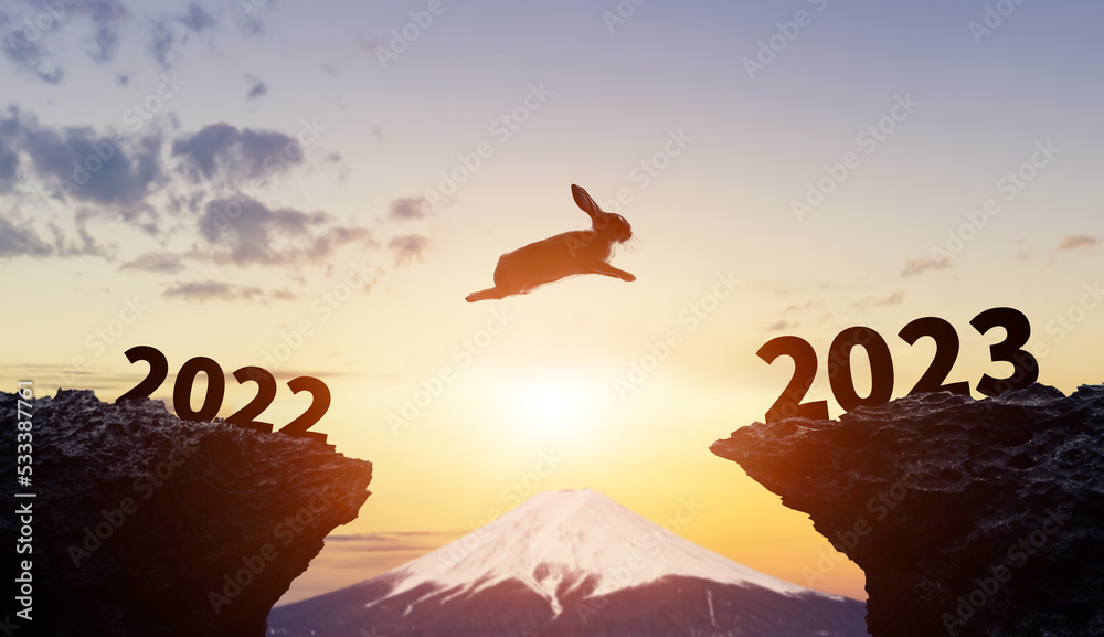 2022から2023へジャンプするウサギ　2023年年賀状素材 - obrazy, fototapety, plakaty 