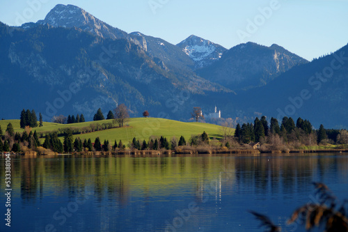 Fototapeta Naklejka Na Ścianę i Meble -  scenic and serene lake Bannwaldsee in Schwangau with the Bavarian Alps in the background on a sunny November day (Allgaeu, Bavaria, Germany)