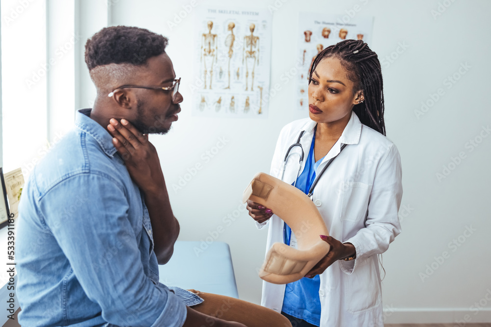 Doctor examining patient wearing neck brace in medical office. Traumatologist talking to male patient in cervical collar. Medical interview, professional help, injury treatment after accident