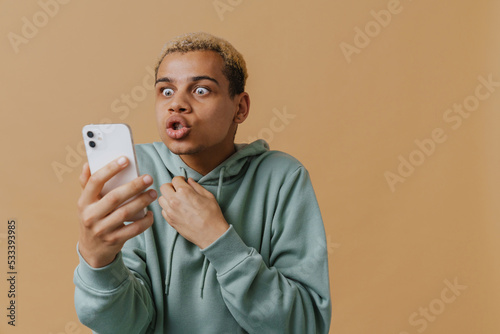 Blonde shocked man gesturing and talking on cellphone © Drobot Dean