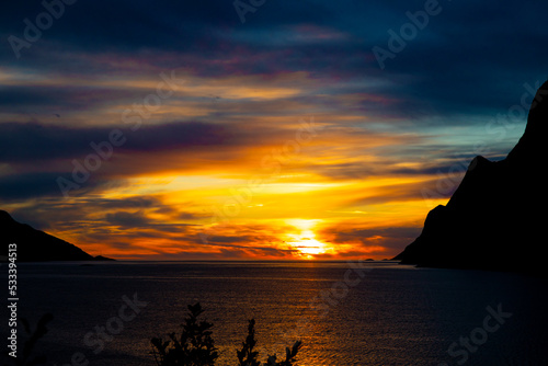 A beautiful orange sunset over the Norwegian fjords