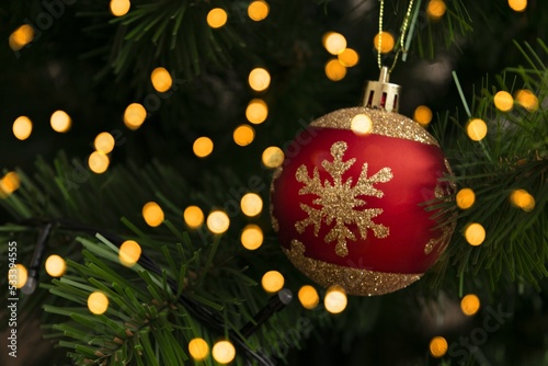 Christmas decorarion background. One red christmas ball on christmas tree photo
