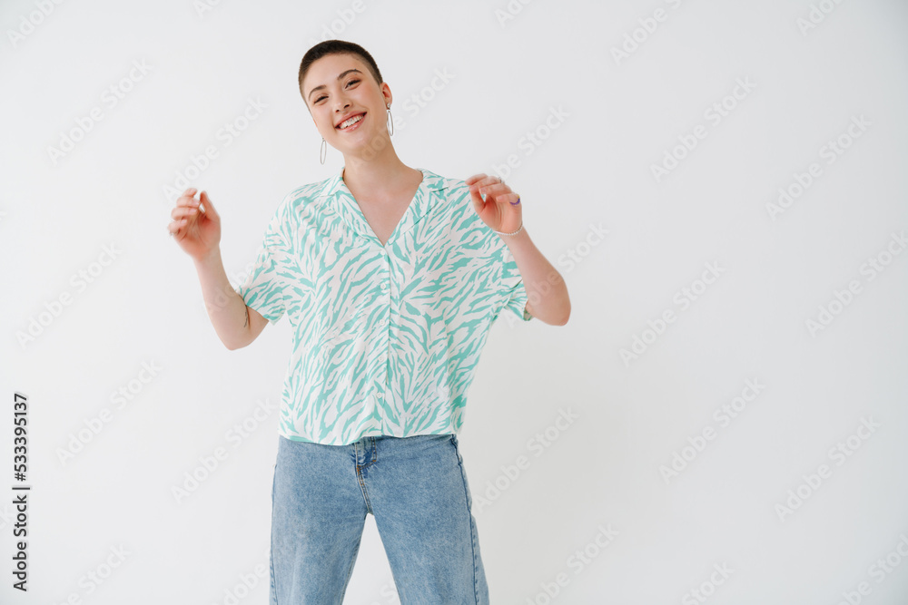 Excited european woman with short hair dancing while smiling at camera Excited european woman with short hair dancing while smiling at camera
