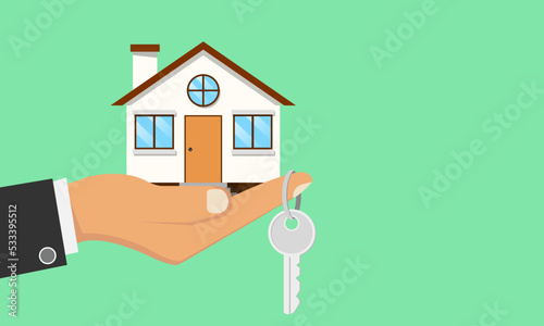 Businessman holds a house in his hand and a house key at his fingertips. The hand is standing out for leasing or resale. is a real estate