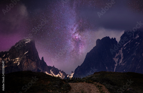 Beautiful night landscape. High mountains in the starry night with bright milky way galaxy. 