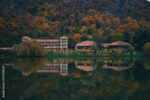 Luxury hotel in a nature park in autumn, Dense Smoke Rises From the Chimney. House by the lake in autumn, bike path near the lake, Recreation walk, and cycle path road sign. 