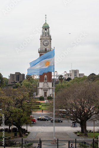 clock tower in the city and a flag from Argentina behind