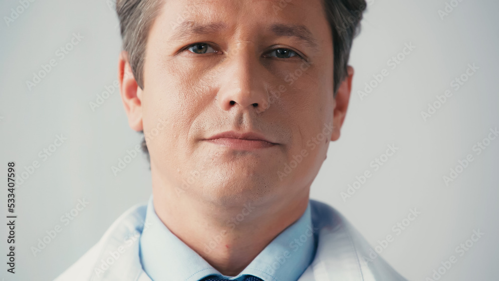 portrait of confident doctor looking at camera isolated on grey. portrait of confident doctor looking at camera isolated on grey.