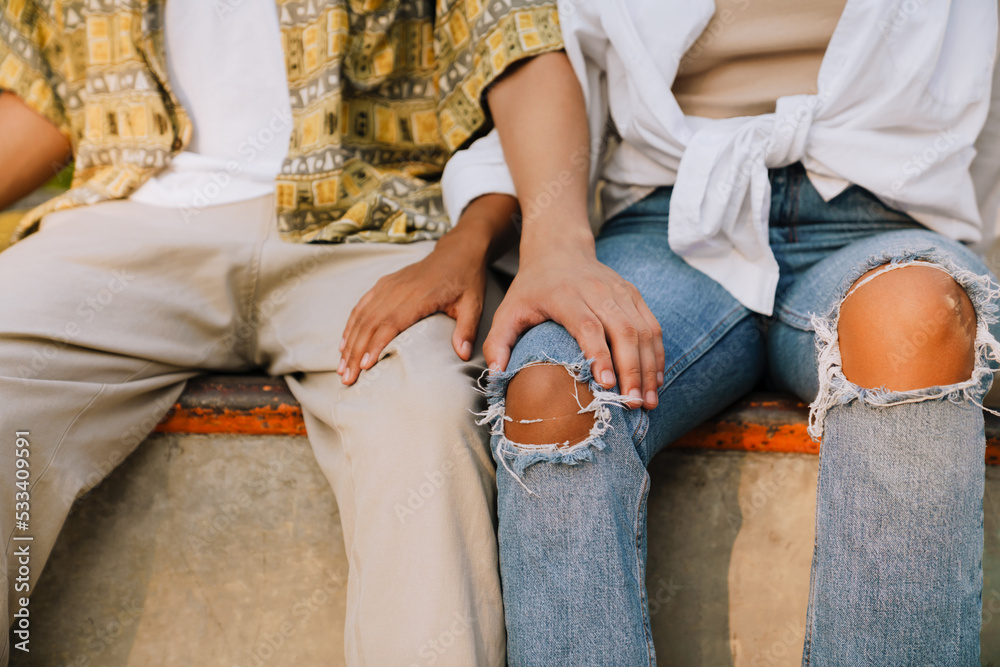 Young girl and boy holding each other for knee Young girl and boy holding each other for knee