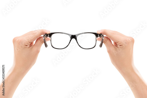 Male hands holding a pair of glasses