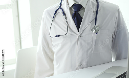 Doctors working on computer at hospital.