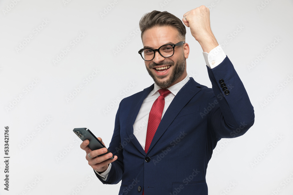 handsome businessman reading emails and celebrating victory handsome businessman reading emails and celebrating victory