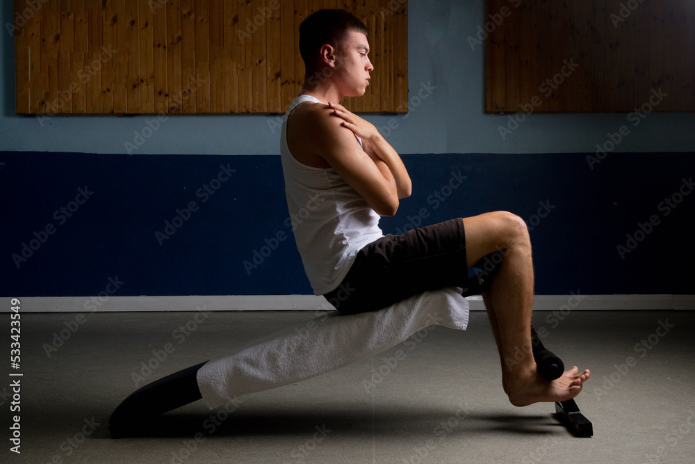 Fototapeta premium Nineteen year old teen boy doing situps in a tanktop