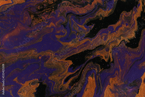 Acrylic texture made in fluid pour technique. Background in purple, gold and black colors.