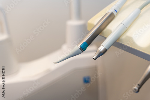 Tools used by doctors in a modern dental clinic next to the chair for operations