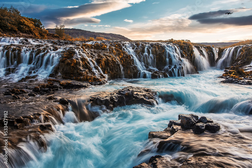 Fantastic Bruarfoss Waterfall. Amazing nature of Iceland. Iceland popular place of travel and touristic location. Wonderful Icelandik landscape during sunset. Creative image. Natural background © jenyateua