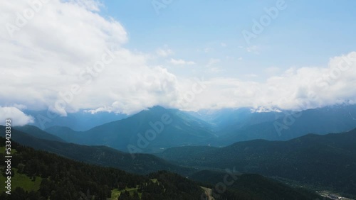 panorama of mountain peaks with clouds in summer in teberda shot on a drone photo