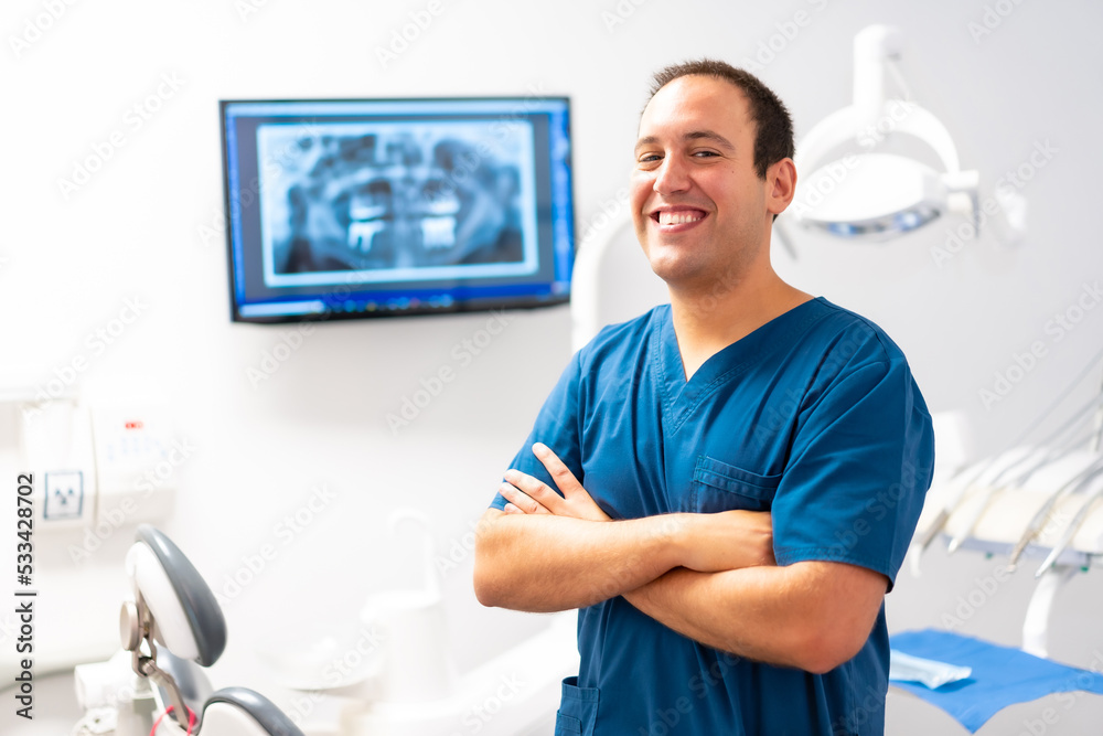 Dental clinic, portrait of caucasian female dentist with arms crossed and smiling Dental clinic, portrait of caucasian female dentist with arms crossed and smiling