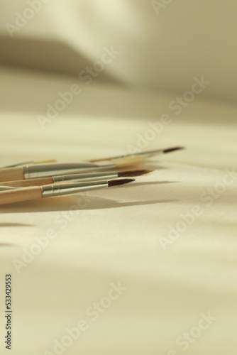 set of paint brushes and white paper