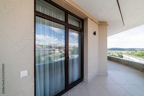 new clean balcony with large floor-to-ceiling windows