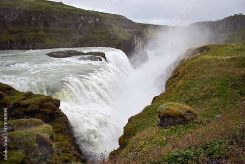 Gullfoss falls. Waterfall in green rocky landscape, Iceland, Europe.