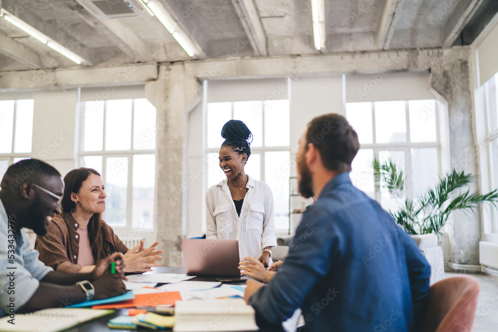 Group of multiethnic coworkers having meeting in office Group of multiethnic coworkers having meeting in office
