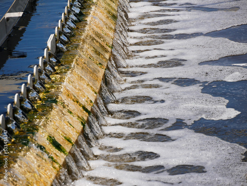 Canvas Print treated water flowing thru a weir in a sedimentation trank in a waste water trea