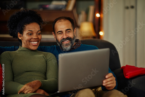 Couple celebrating Christmas at home and using technology