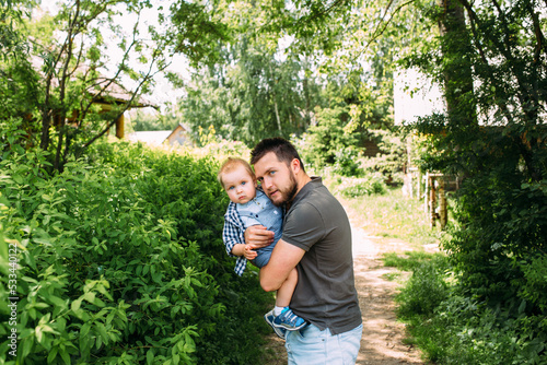 Dad and little son spend time together in the summer outdoors, have fun