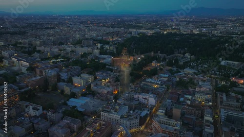 High angle view of evening city. Illuminated streets and residential buildings in Tiburtino borough. Rome, Italy photo