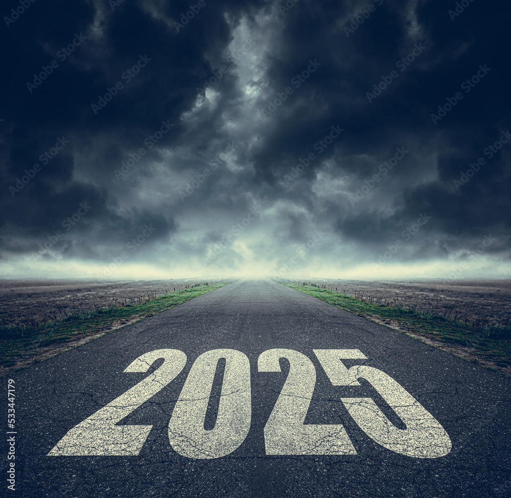 2025 written on highway road in the middle of asphalt road and dark cloudy  sky. Future vision 2025 Stock Photo