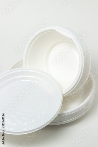 Disposable plastic tableware isolated on white background. Plates made of plastic