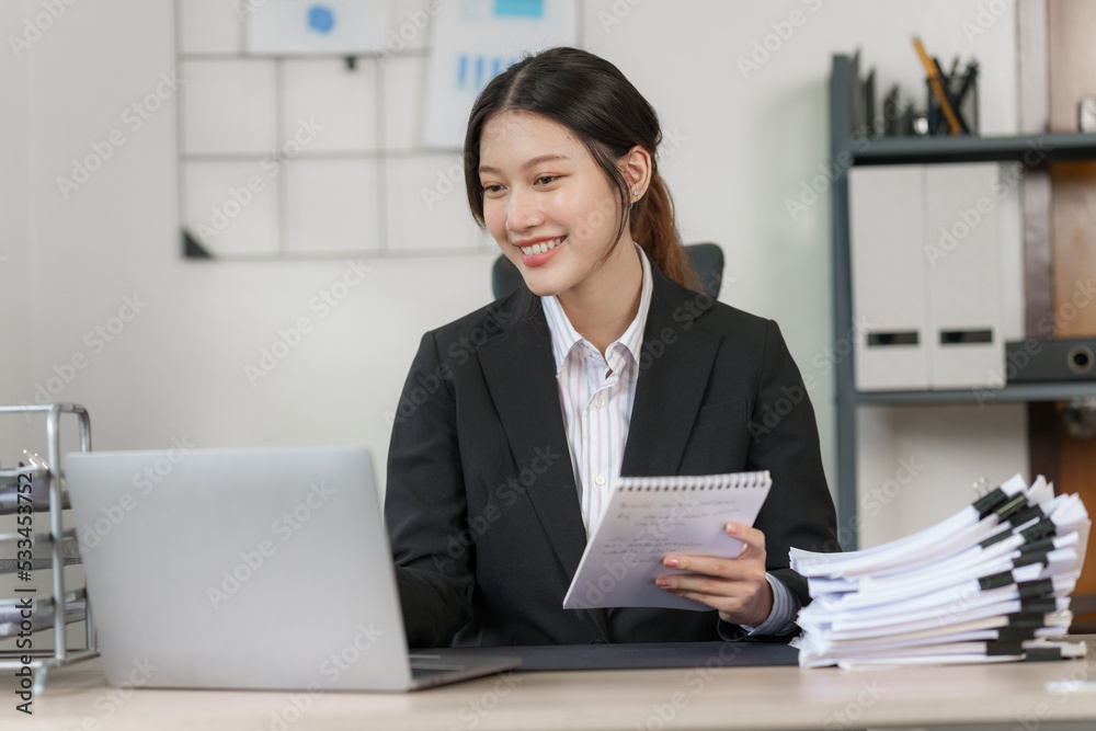Happy attractive joyful asian woman working at workstation. Happy attractive joyful asian woman working at workstation.