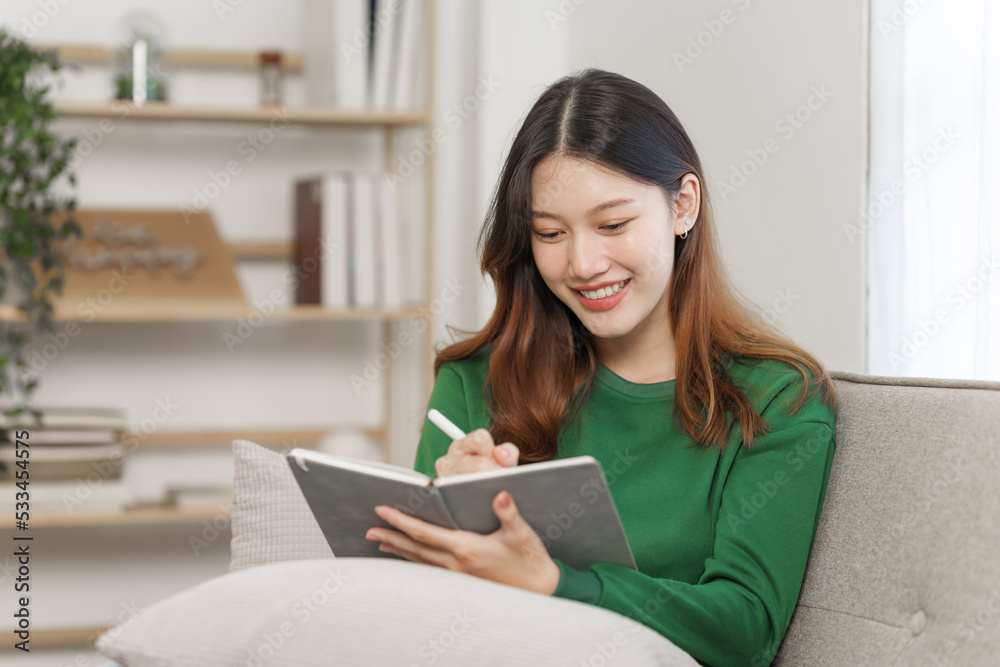 Happy young attractive smiling asian woman enjoying relax time at apartment. Happy young attractive smiling asian woman enjoying relax time at apartment.